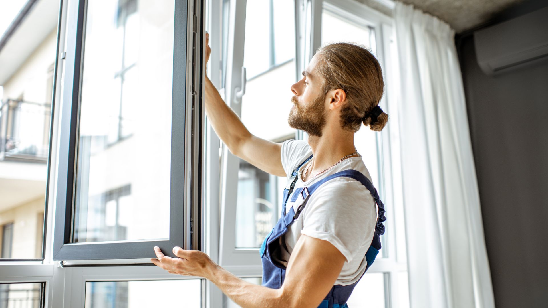 Workman Adjusting Window Frames 